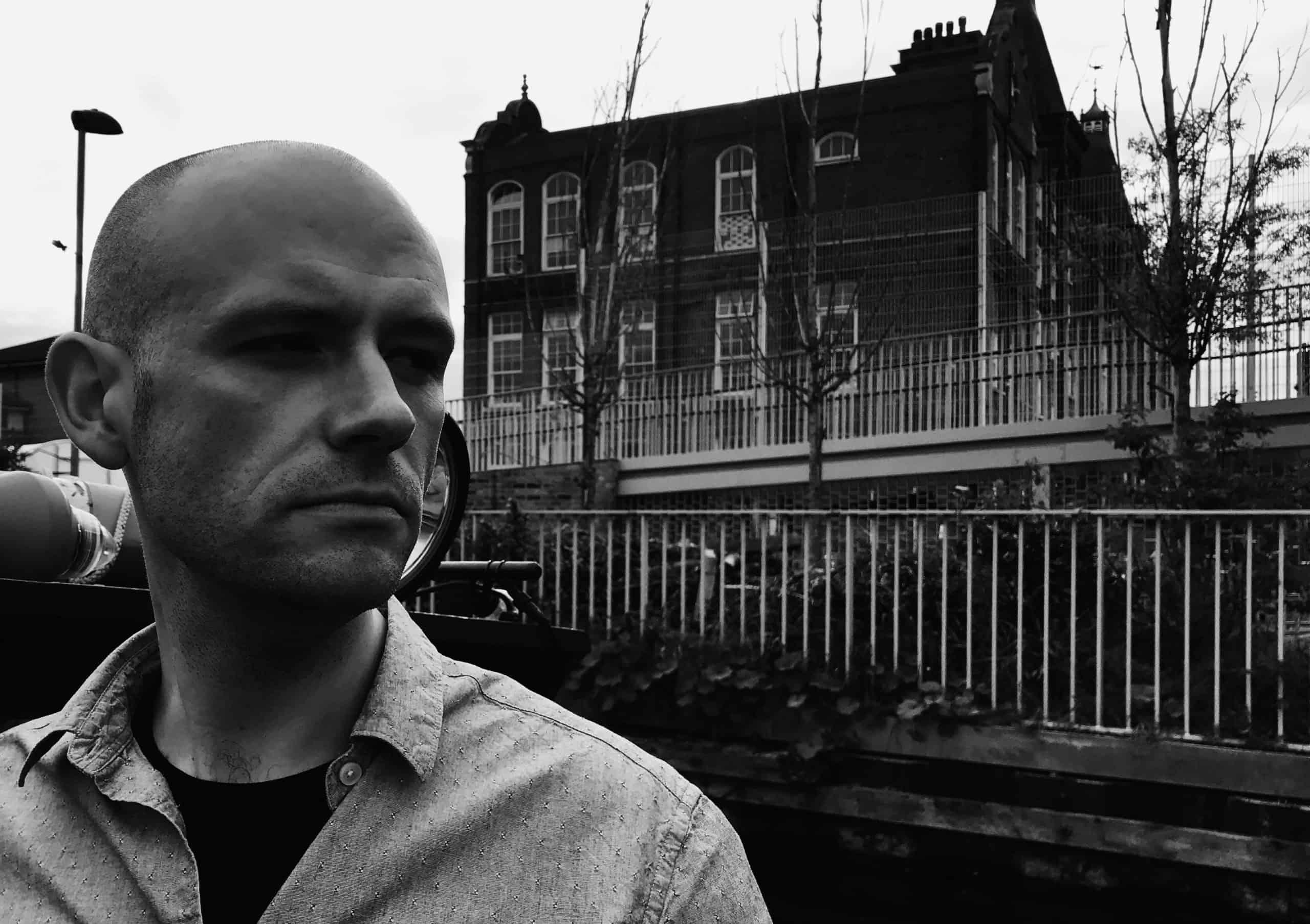 Drum and Bass artist in front of house 